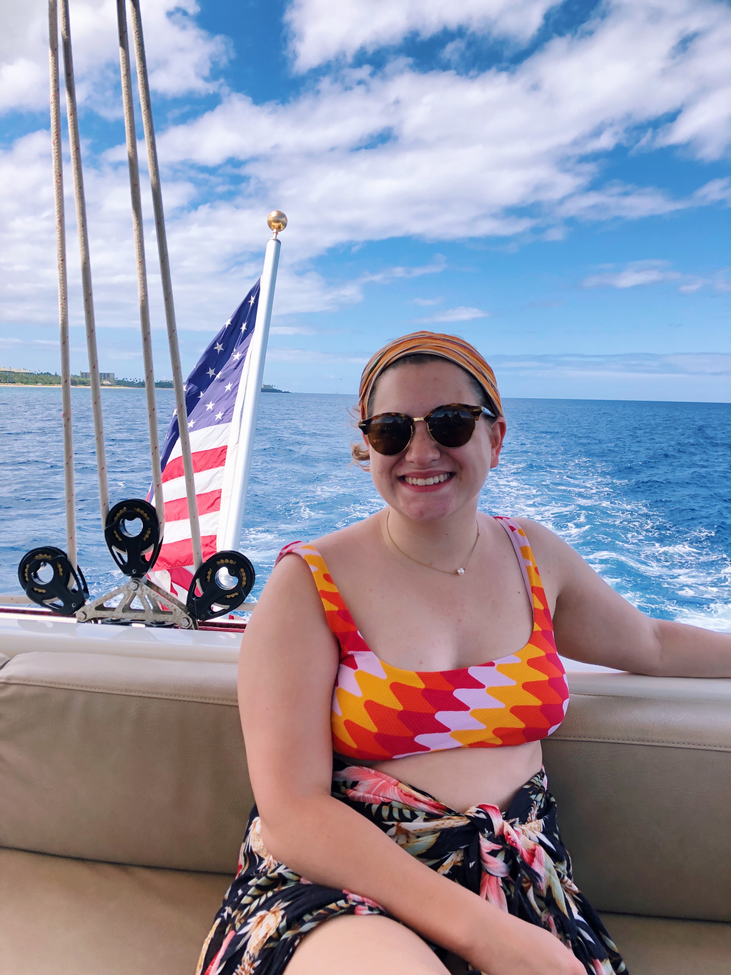 I am on a boat and you can see the ocean behind me. 